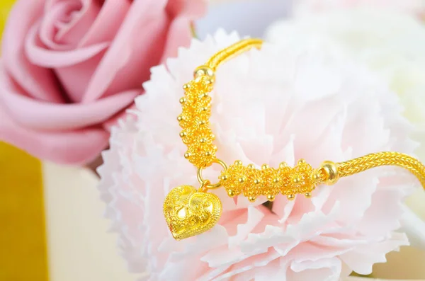 Gold Bracelet on beautiful pink flower.