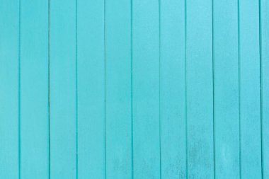 Old turquoise wooden panel texture as background.