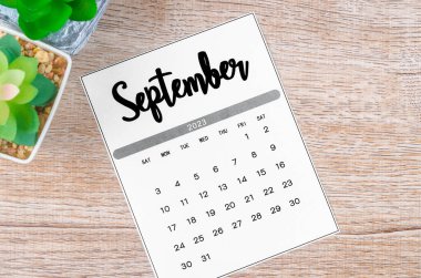 September 2023 Monthly calendar for 2023 year on wooden background.