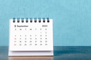 September 2023 desk calendar on blue color background, Vintage style.