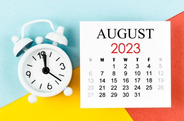 A August 2023 Monthly calendar year with alarm clock on colorful background.