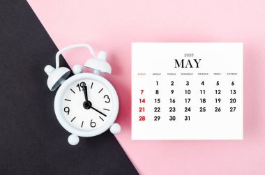 May 2023 Monthly calendar year with alarm clock on pink and black colour background.