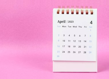 April 2023 desk calendar on pink colour background.