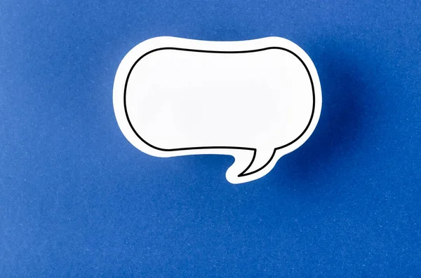 Speech bubble with copy space communication talking speaking concepts on blue background.