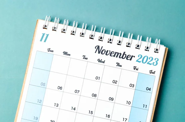 November 2023 calendar desk for the organizer to plan and reminder isolated on blue background.