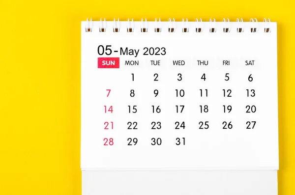 May 2023 Monthly desk calendar for 2023 year on yellow background.