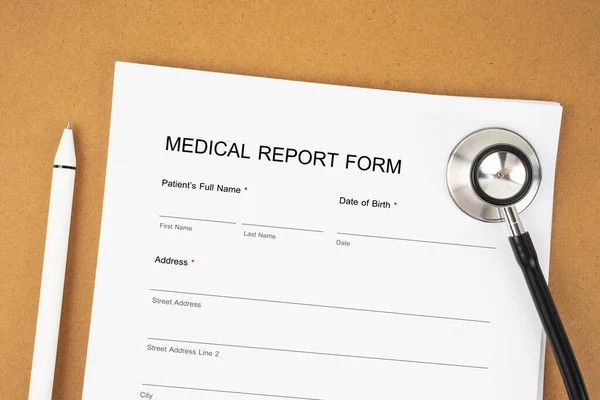 Medical Report form (Health Questionnaire, patient registration form) and stethoscope with pen is prepared to fill out the form.