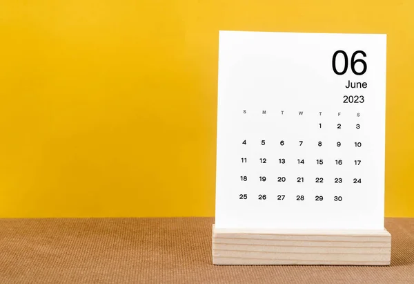 stock image June 2023 Monthly calendar for 2023 year on yellow table.