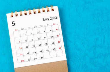 May 2023 Monthly desk calendar for 2023 year on blue background.