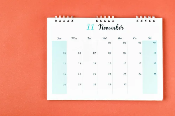 November 2023 calendar desk for the organizer to plan and reminder on red background.