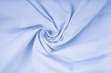 Light blue crumpled fabric texture background. Close up.