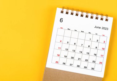 June 2023 Monthly desk calendar for 2023 year on yellow background.
