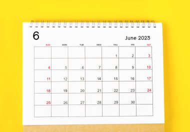 June 2023 Monthly desk calendar for 2023 year on yellow background.