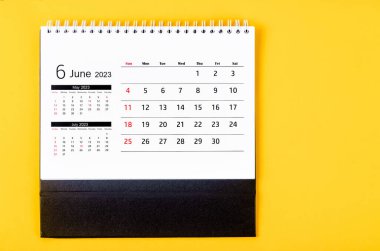 June 2023 Monthly desk calendar for 2023 year on yellow background.