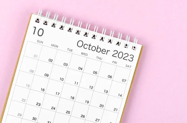 October 2023 calendar desk for the organizer to plan and reminder isolated on pink background.