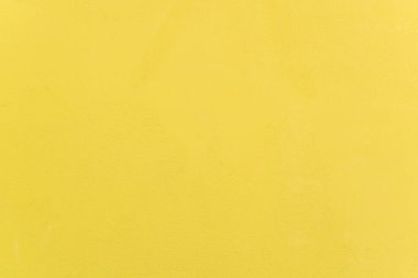 Açık sarı beton duvarın arkaplanı.