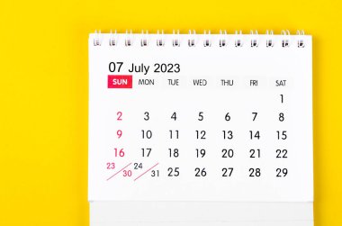 July 2023 Monthly desk calendar for 2023 year on yellow background.