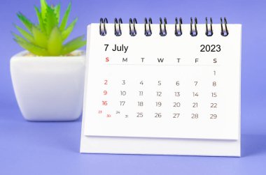 July 2023 Monthly desk calendar for 2023 year on purple background.