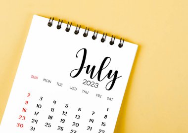 July 2023 Monthly desk calendar for 2023 year on yellow background.