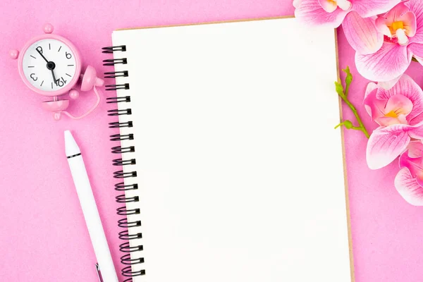 あなたのテキストやメッセージのためのピンク色の蘭とブランクオープンノートブックとクロック — ストック写真