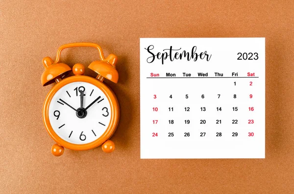 2023年9月主催者のカレンダーは黄色の背景に目覚まし時計で2023年を計画する — ストック写真