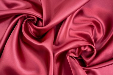 Pürüzsüz kırmızı ipek ya da saten lüks kumaş dokusu arka planı.