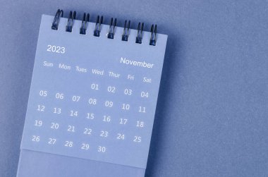 November 2023 Monthly desk calendar for 2023 year on blue background.