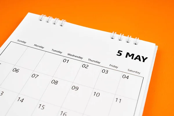 May 2024 month calendar on orange color cover background. Monthly calendar concepts.