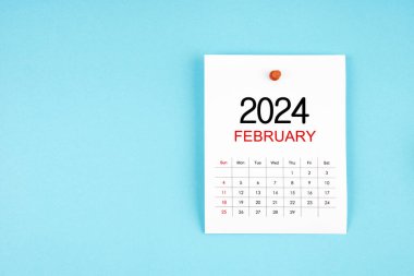 Şubat 2024 takvim sayfası mavi arkaplandaki iğneye basılı.