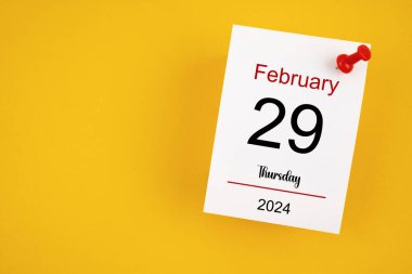 February 29th calendar for February 29 and wooden push pin on yellow background. Leap year, intercalary day, bissextile. clipart