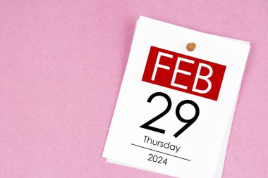 February 29th calendar for February 29 and wooden push pin on pink background. Leap year, intercalary day, bissextile. clipart