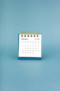 Şubat 2024 mavi arkaplan üzerine beyaz masa takvimi.
