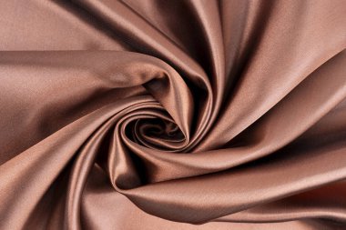 Arkaplan olarak kahverengi ipek tekstil.