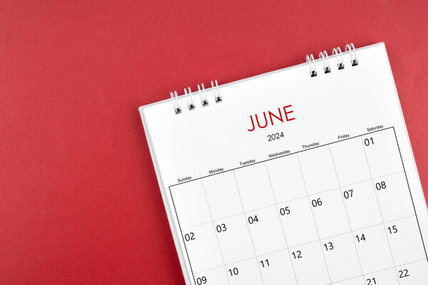 June 2024 desk calendar on red color background.