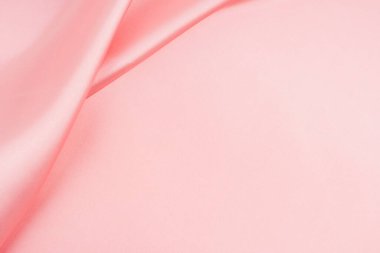 Arkaplan olarak pembe ipek kumaş dokusu.