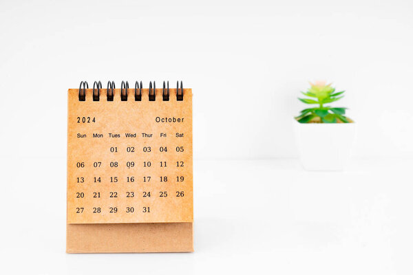 October 2024 Monthly desk calendar for 2024 year with plant pot on white background.