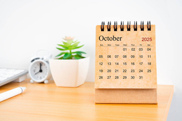 Front view of October 2025 desk calendar on worktable.