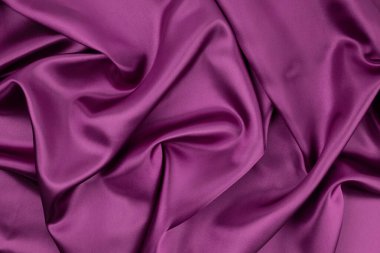Arka plan ve tasarım için mor kumaş dokusu, güzel buruşmuş ipek ya da keten deseni..