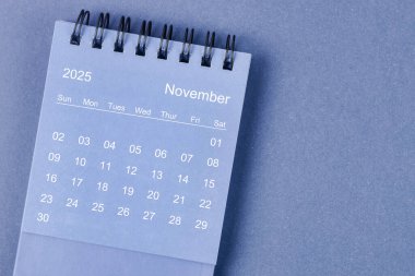 November 2025 Monthly desk calendar for 2025 year on blue color background. clipart