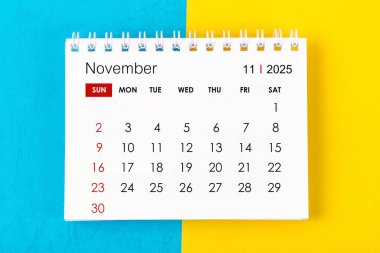 November 2025 Monthly desk calendar for 2025 year on blue and yellow background. clipart