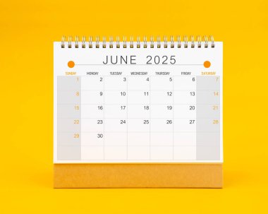 Sarı arkaplan üzerinde Haziran 2025 masa takvimi, Ön görünüm.