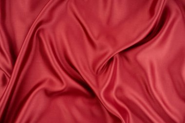 Arka plan olarak güzel koyu kırmızı ipek kumaş dokusu, yakın plan