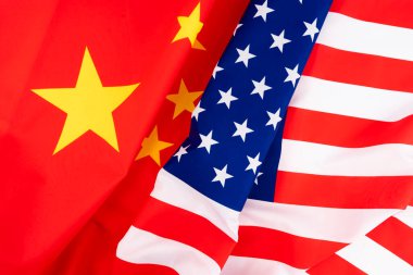 Waving of USA flag and China flag for barrier tariff trade war , economy competition and politic war from united states of America and China concept.