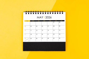 Randevu almak için 2026 yılının masa takvimi sarı arka planda olabilir.