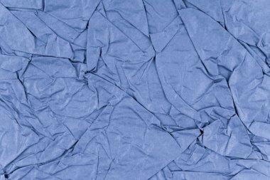 Arkaplan olarak mavi buruşmuş kağıt dokusu.