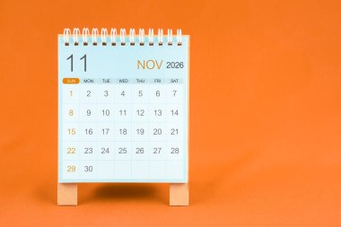 Kasım 2026 Turuncu tekstil arkaplan takvimi.