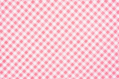 Arkaplan olarak pembe renkli ekose kumaş, tekstil malzemesi.