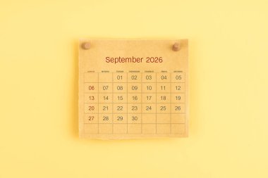 Eylül 2026 kahverengi takvim üzerinde ahşap raptiye.