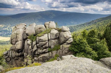 Yazın bulutlu gökyüzü altında Frydlant siperleri adı verilen inanılmaz manzaralı kaya oluşumu. Jizera Dağları, Çek Cumhuriyeti, Avrupa.
