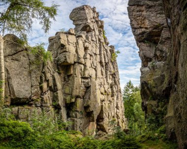 Beautiful high sandstone rocks hidden in mysterious summer forest. Lusatian Mountains, Czech Republic, Europe. clipart